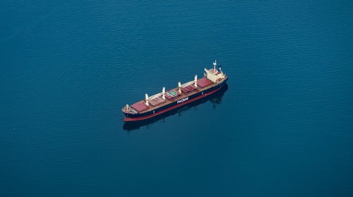 Freighter ship in the middle of blue water