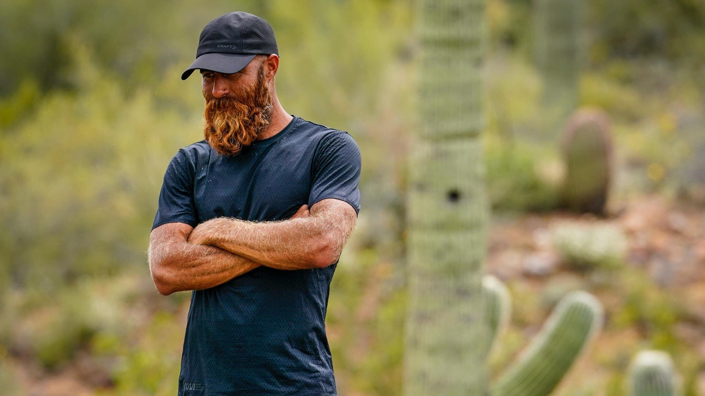 Tommy Riv crosses his arms in nature