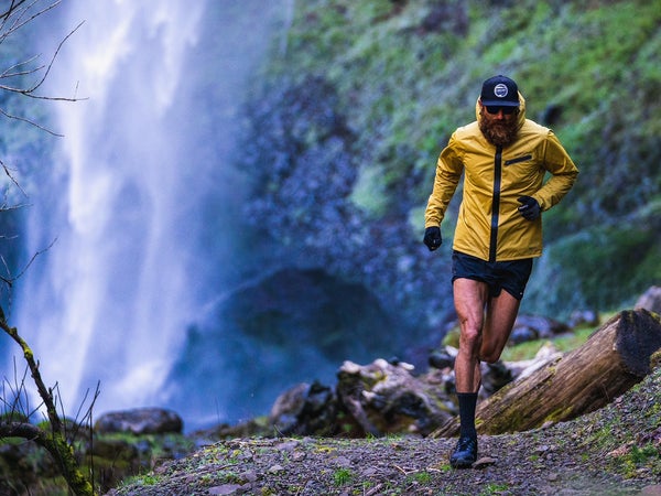 Tommy Riv running near a waterfall
