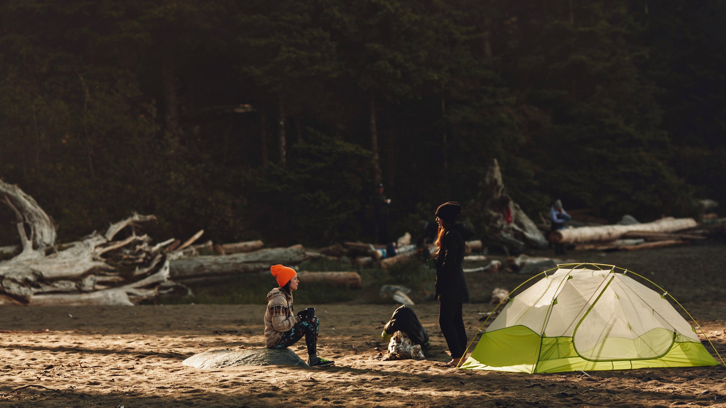 Two friends talking near a tent