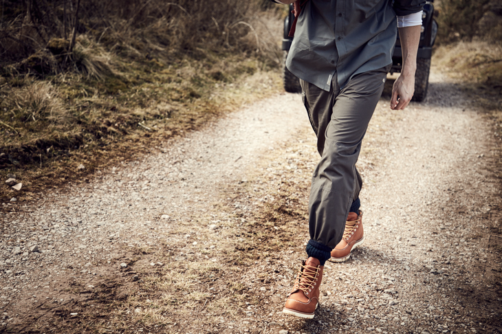 Unknown Man walking down a dirt road wearing Craghoppers number one selling Kiwi Trouser.
