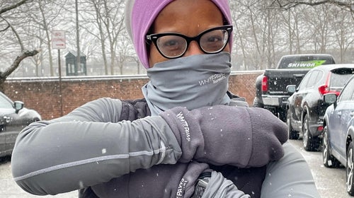 Woman wearing mittens in snow