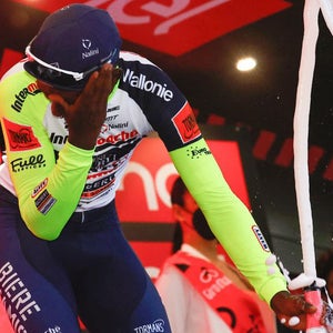 Biniam Girmay winces after being struck by a flying cork.