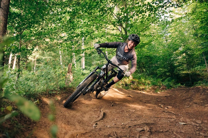 A mountain biker taking a curve on a forest trail in Vermont