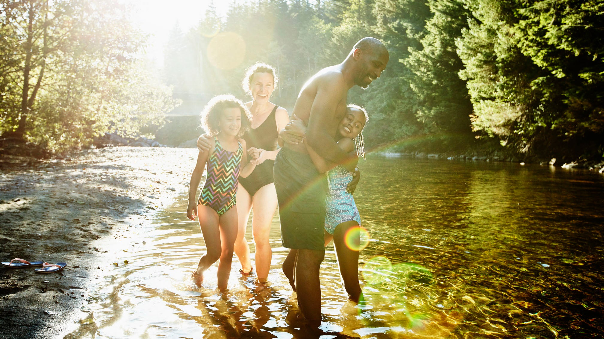 Kids laughing in a river.