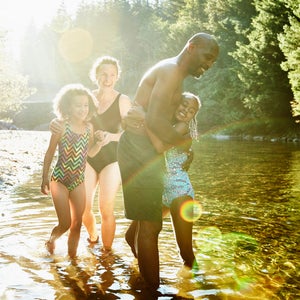 Kids laughing in a river.