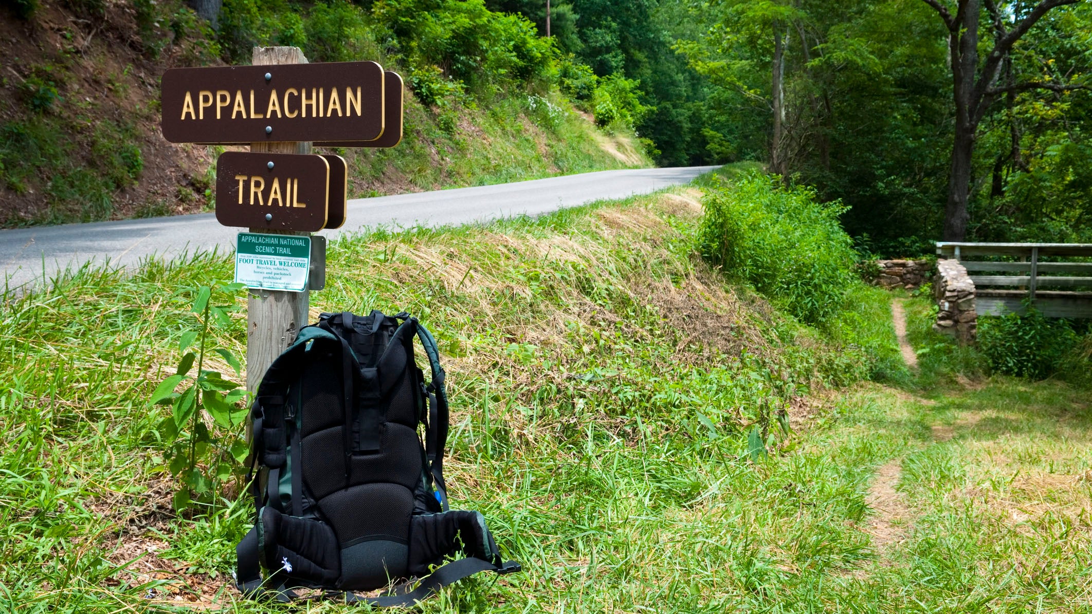 A backpack leaning on the trail.