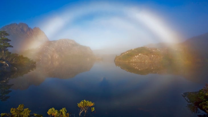 Brocken spectre, brocken bow or mountain spectre, a phenomenon caused when the shadow of an observer is projected and magnified through mist from a higher point with the light shining from behind. Twisted Lakes, Cradle Mountain-Lake St Clair National Park, Tasmania, Australia.