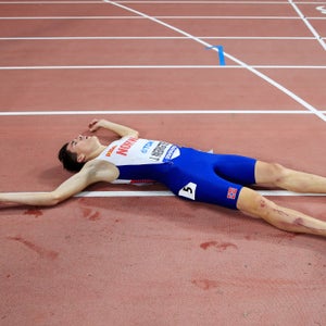 Jakob Ingebrigtsen of Norway lies on the track after crossing the finish line in the Men's 5000 metres final during day four of 17th IAAF World Athletics Championships