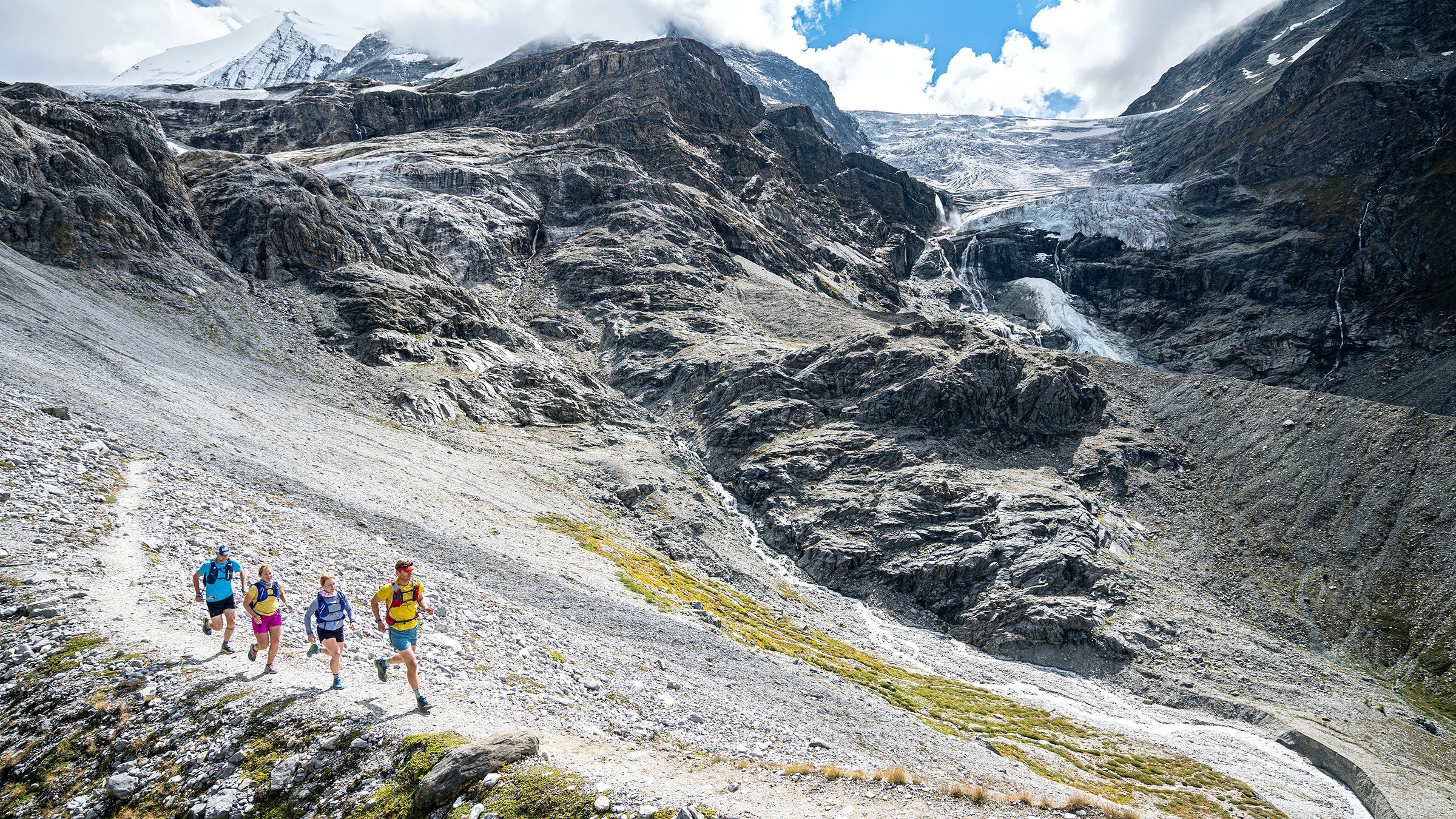 The author, followed by Grace, Annavitte Rand, and Greg Hanscom on the trail, with Turtmann Glacier in the background