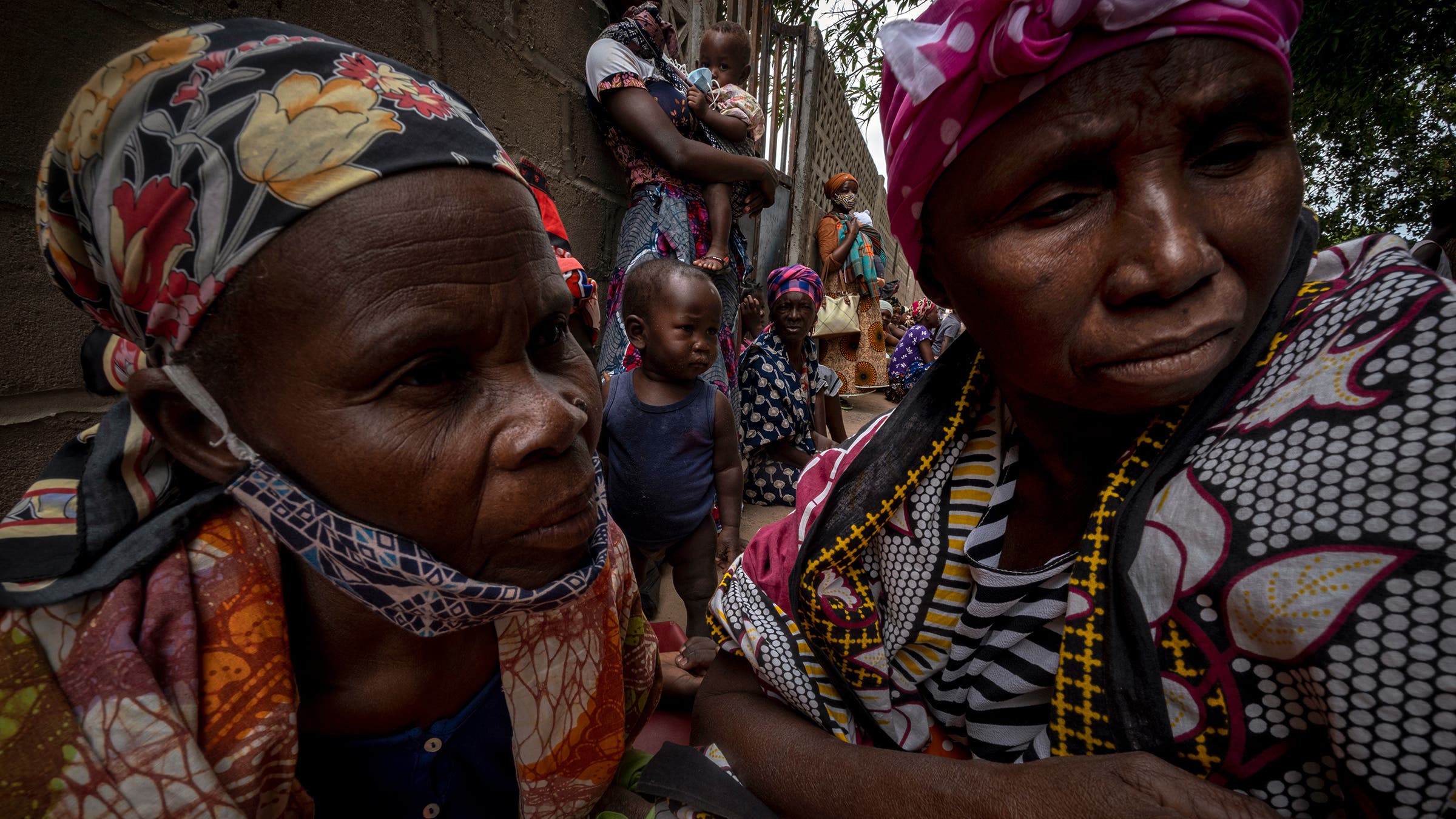 Refugees who fled the Palma attacks awaiting aid at a shelter in Pemba