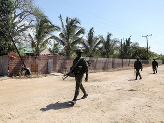 A peacekeeping force from Rwanda patrols outside the Amarula gates.