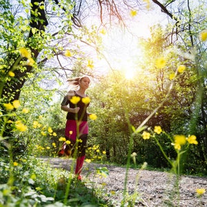 person jogging through the forest in spring