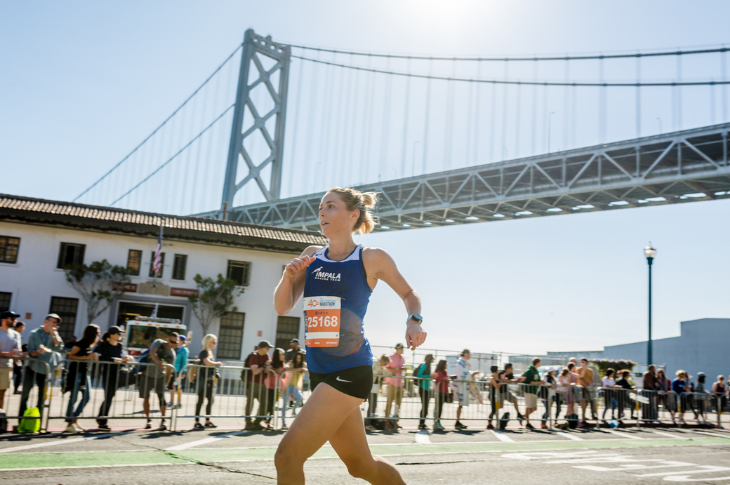 Woman running by the Bay Bridge