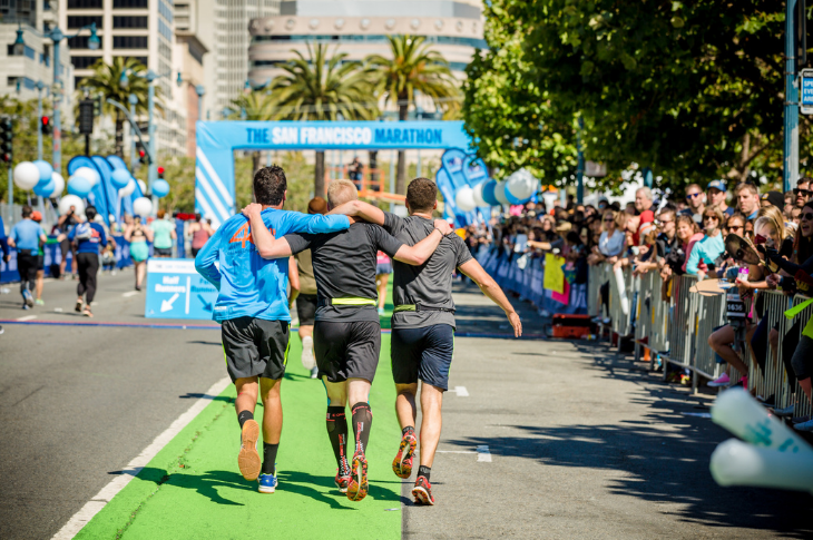 Three men walking toward the San Francisco Marathon finish line