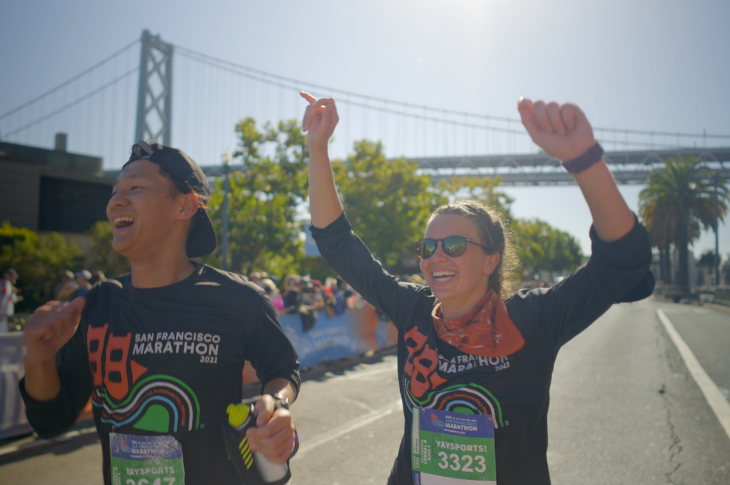 Marathoners celebrating as they reach the finish line
