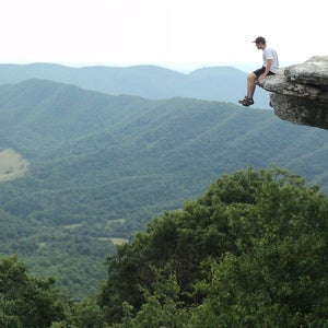 A hiker sits on McAfee Knob.