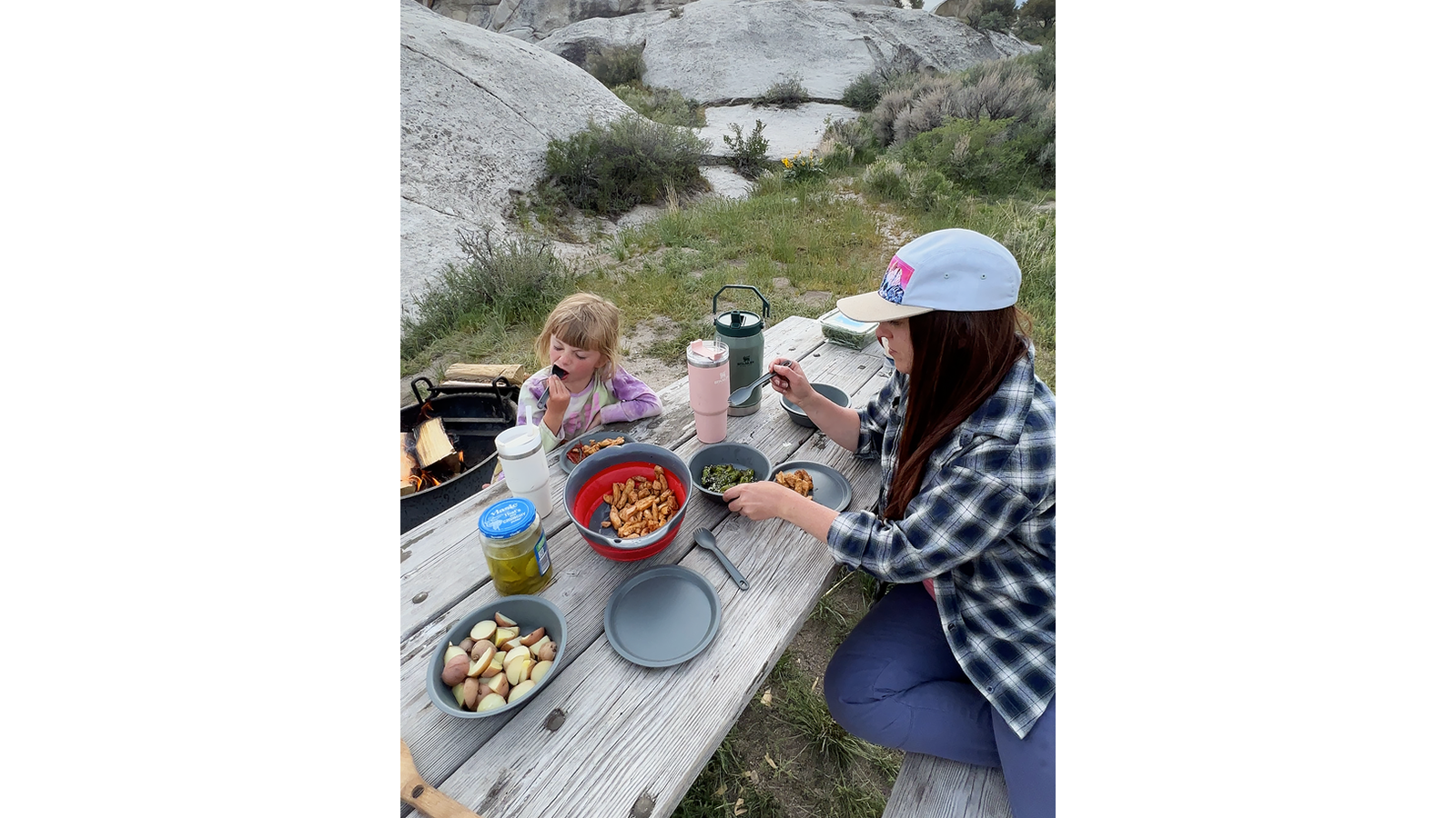 A campground picnic table makes it easier to cook and eat in the wild. .