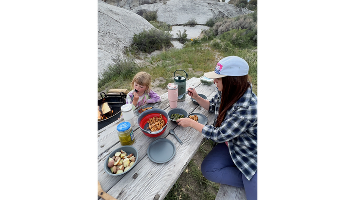 A campground picnic table makes it easier to cook and eat in the wild. .