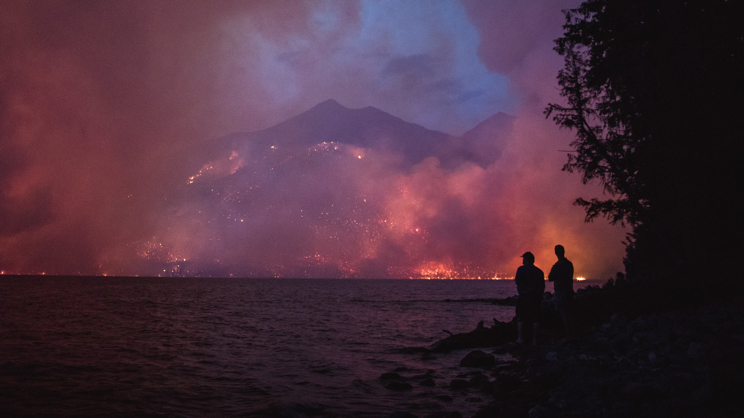The Howe Ridge Fire seen from across Lake McDonald on the night of August 12th, 2018, roughly 24 hours after the fire was started by a lightning strike in an area previously burned in the 2003 Roberts Fire.