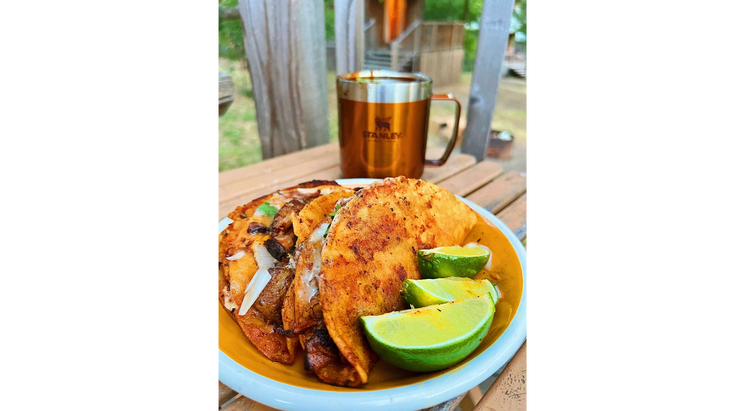 A plate of gourmet campground tacos—fresh limes add flavor.