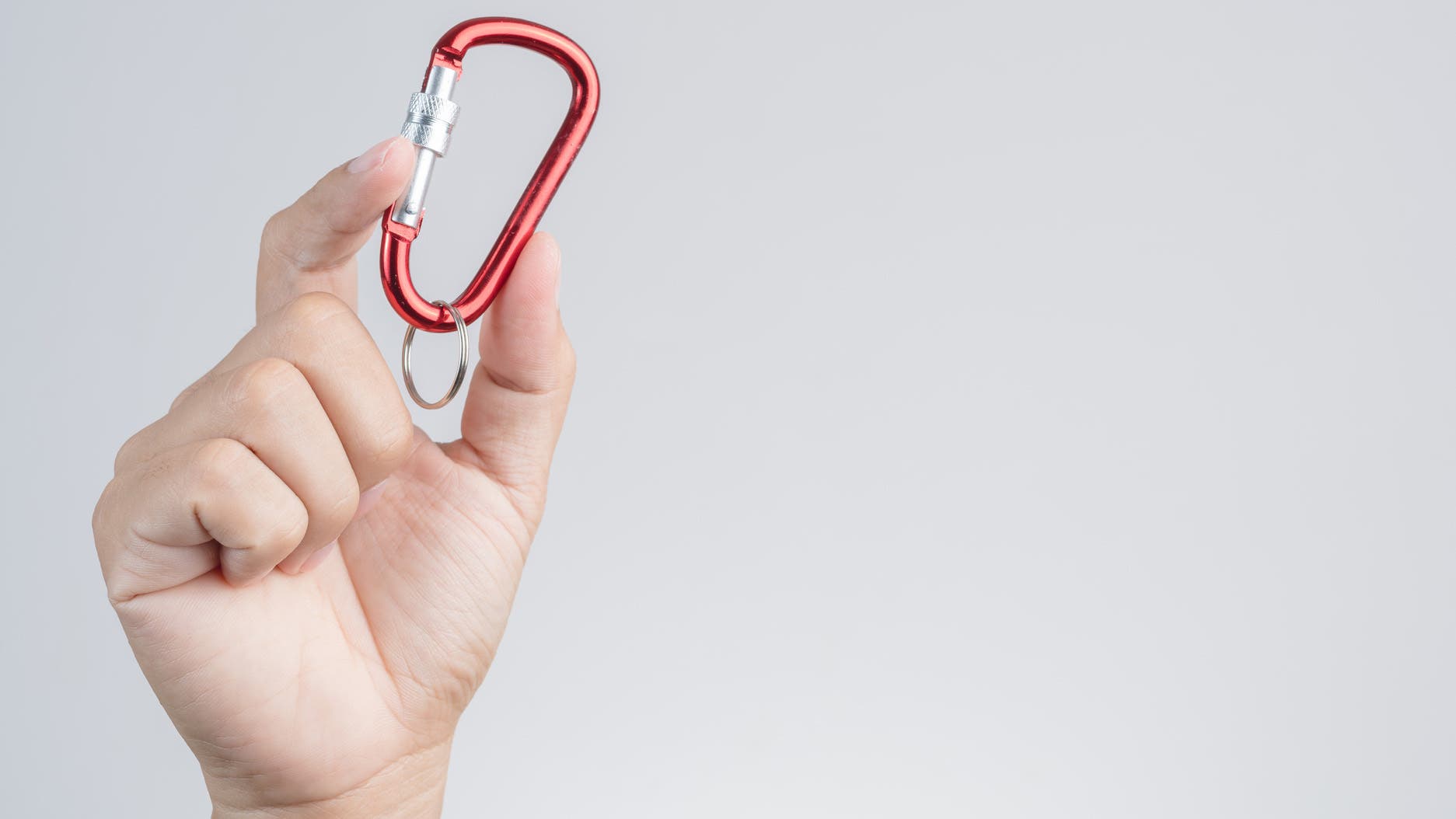 Holding a toy carabiner.