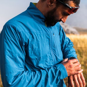 Trail runner using training watch on a foggy day