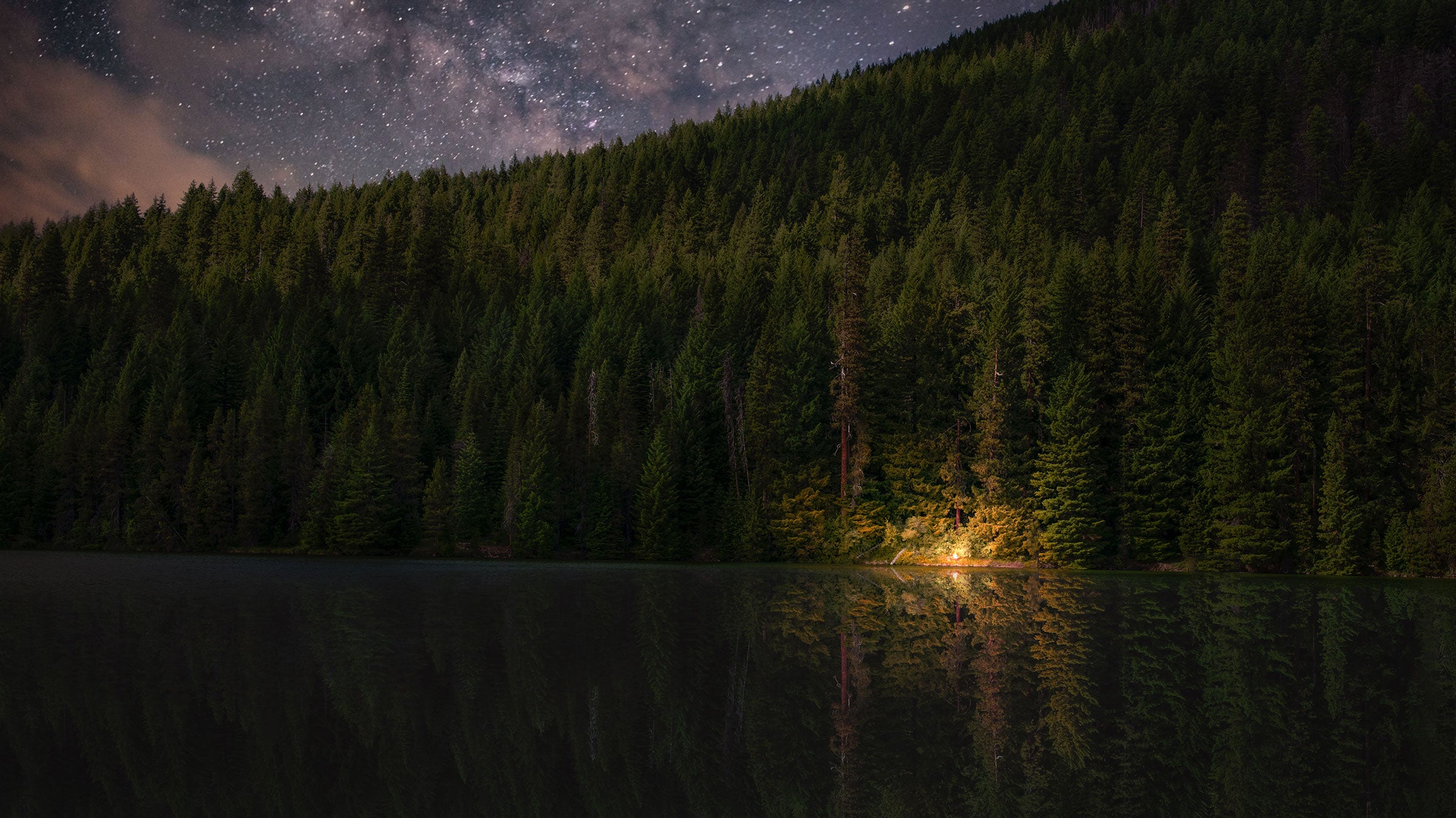 people listening to campfire stories in the distance