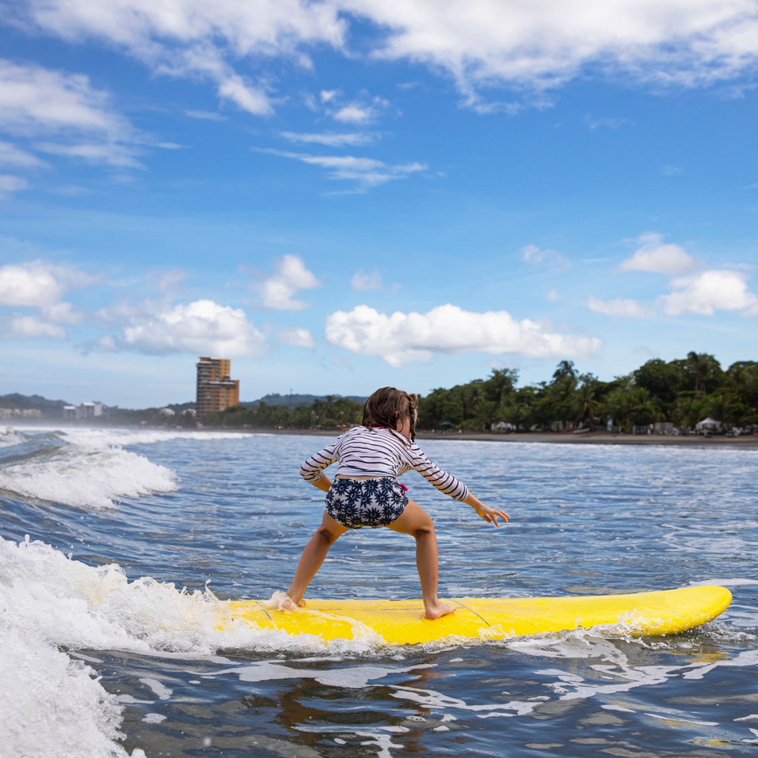 Young girl athlete learning to surf