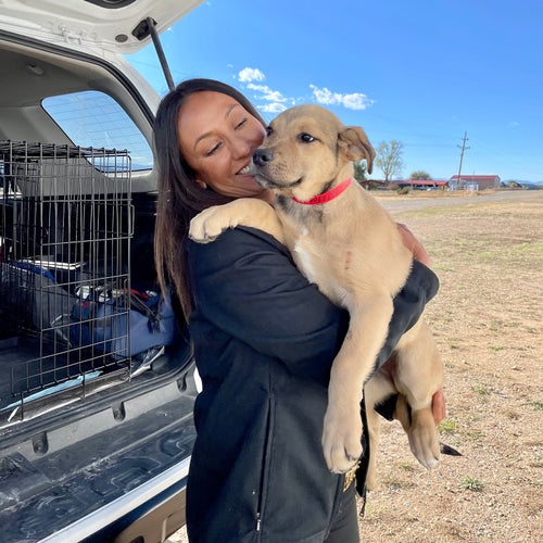 Española Humane volunteer Julie Martinez with one of Porky’s rescued pups
