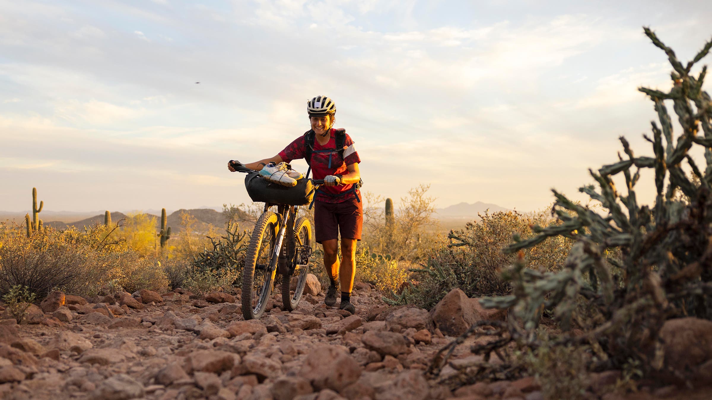Lael Wilcox walking her bike