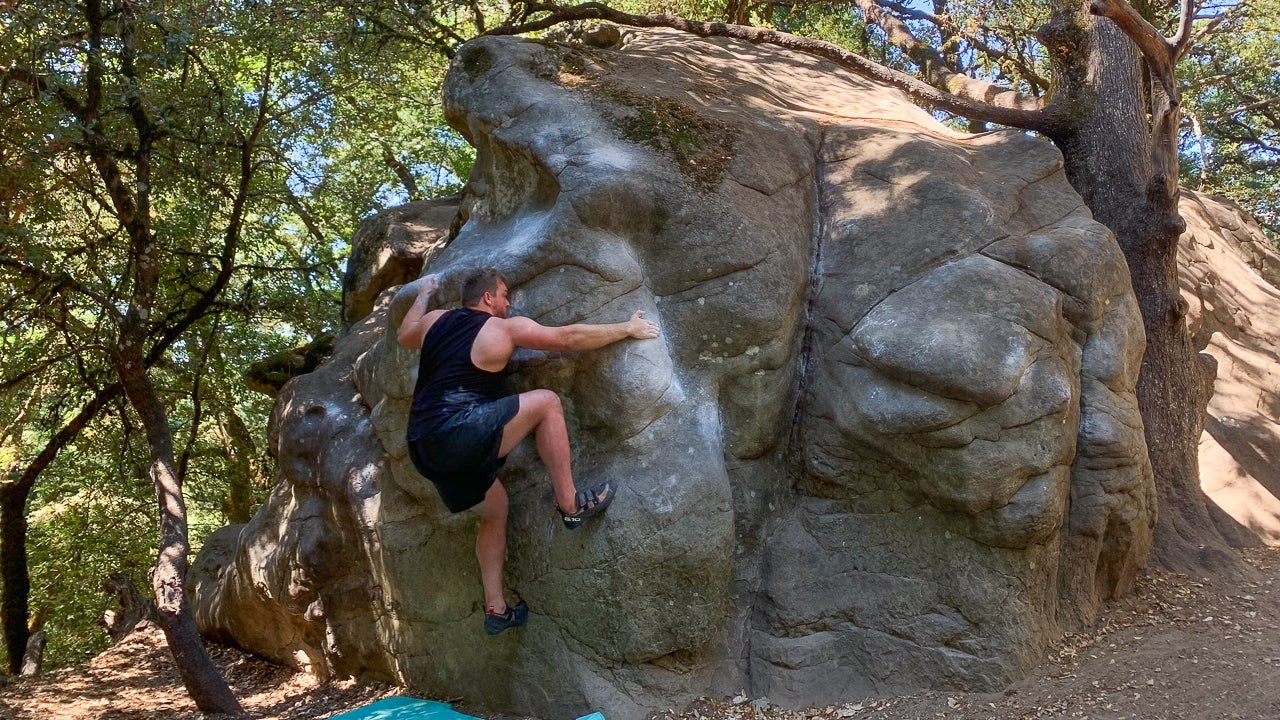 Wes Schweitzer climbs Mrs. Magoo (V2) at Castle Rock, CA.