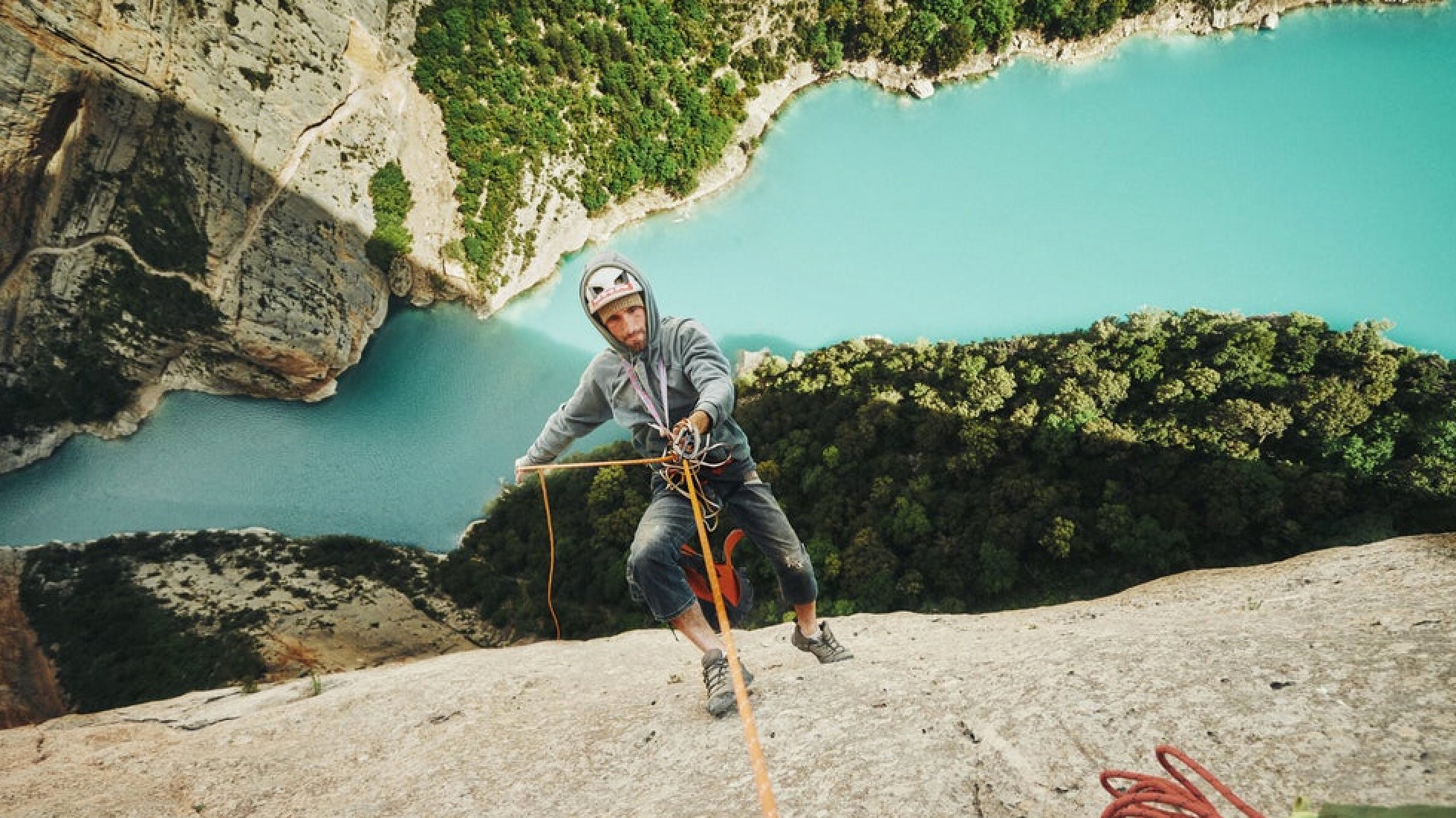 A man rappels into a gorge