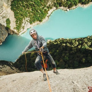 A man rappels into a gorge