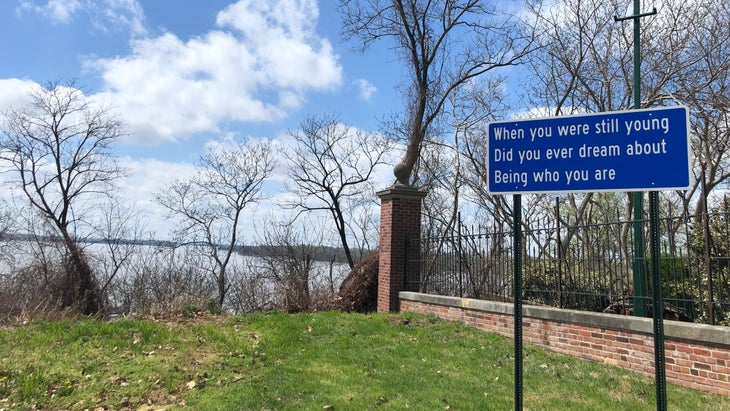 A sign next to a fence