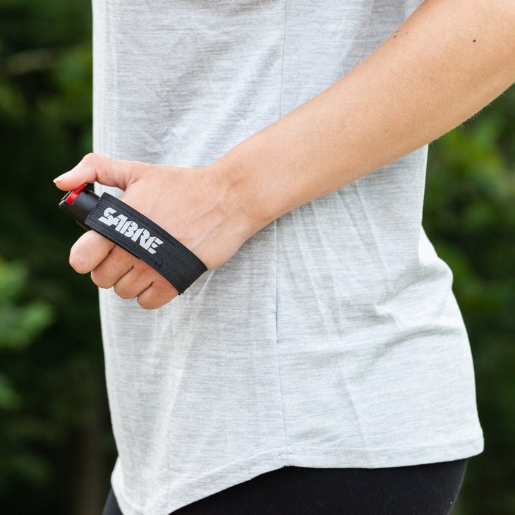 A runner with Sabre's pepper gel on a wrist strap 