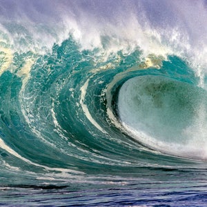 An enormous wave breaks in Hawaii.