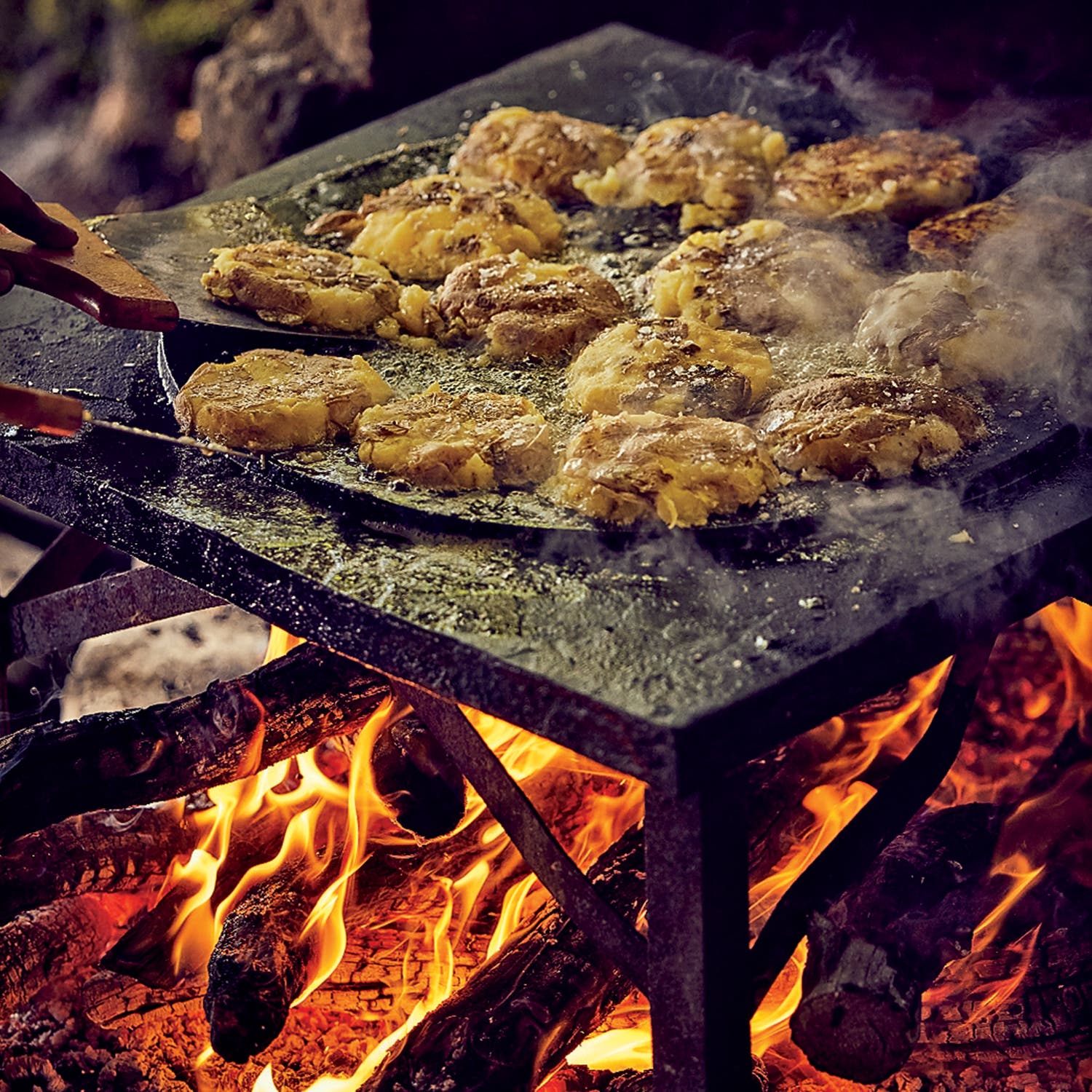 Smashed potatoes cooked over the fire