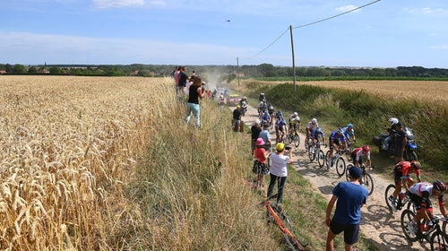 The peloton passes through a cobblestones sector during stage 5 of the 109th Tour de France.