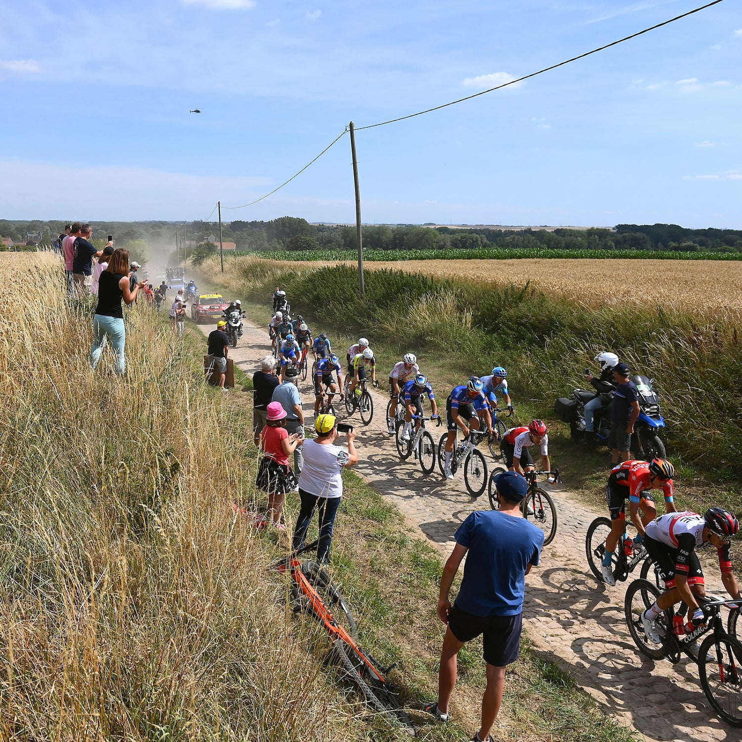 The peloton passes through a cobblestones sector during stage 5 of the 109th Tour de France.