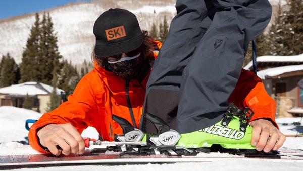 Ski tech adjusting binding to ski boot