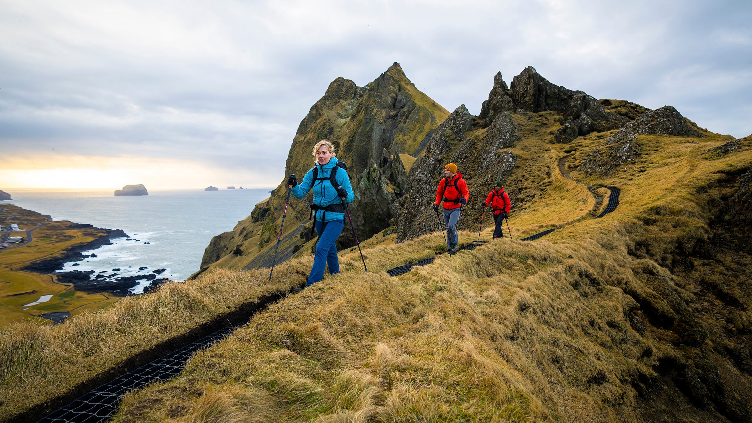 Hikers make their way across a ridge in Iceland