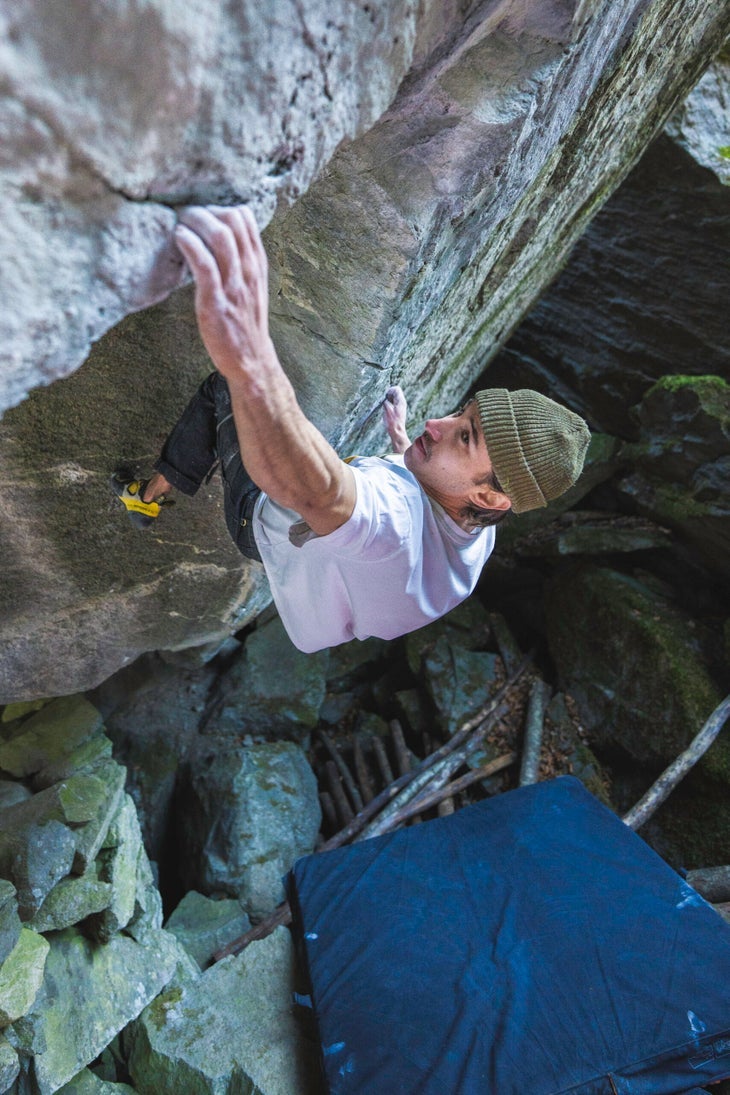 Shawn Raboutou climbs a rock