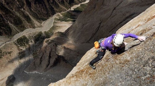 Climber high on a granite wall.