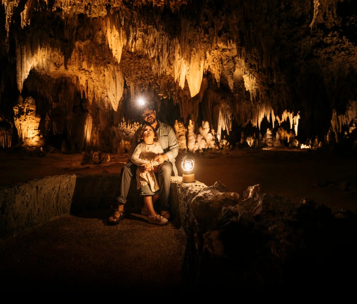 Man and child blow the ground at Carlsbad Caverns National Park