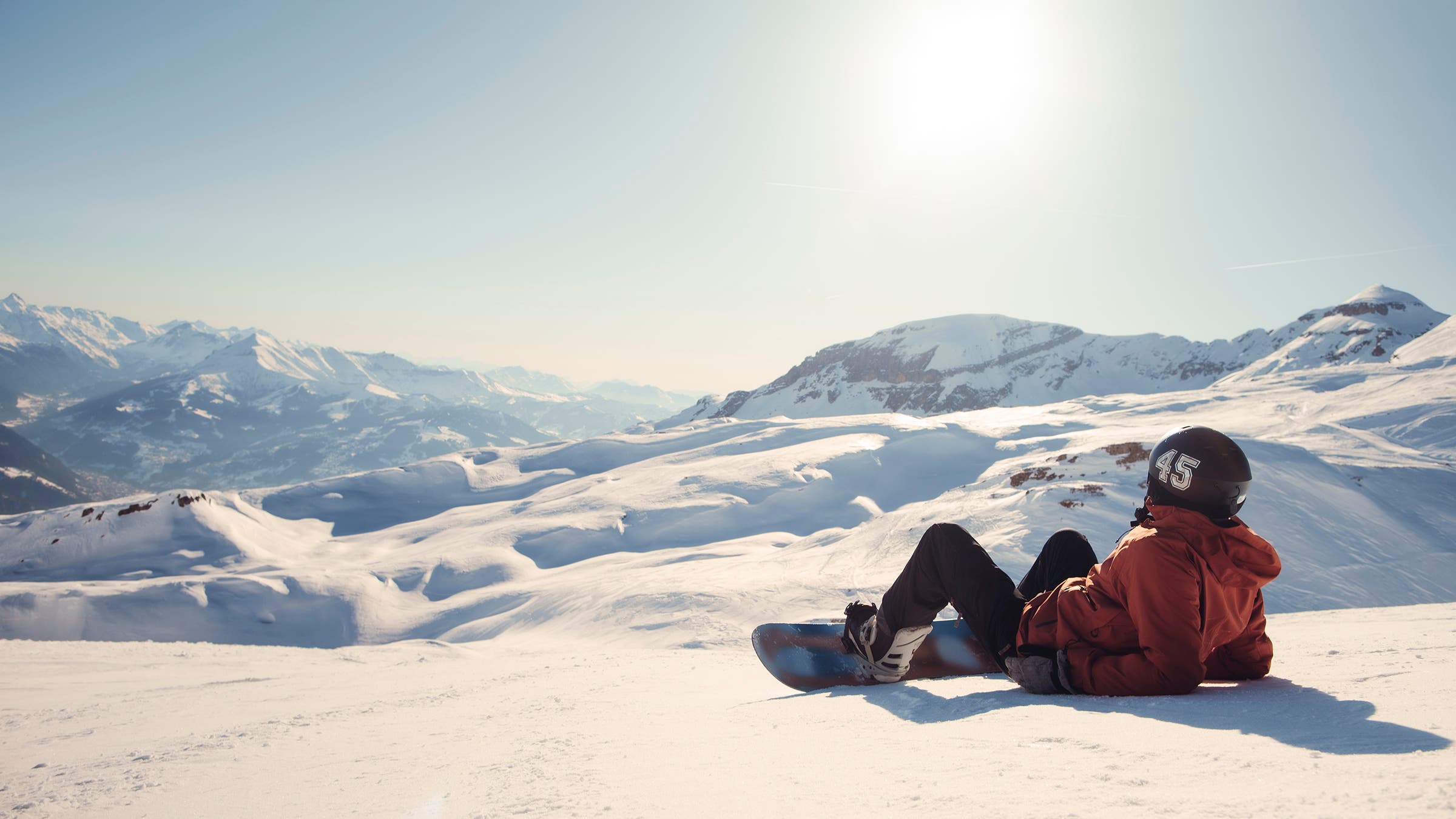 Snowboarder taking in the views from the mountain