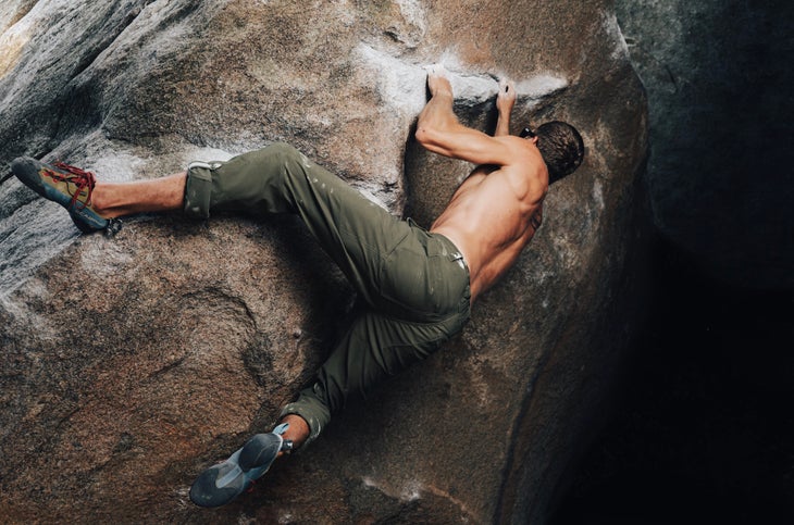 Man rock climbing with no shirt on
