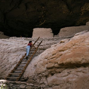 Climbing a ladder into ancient ruins