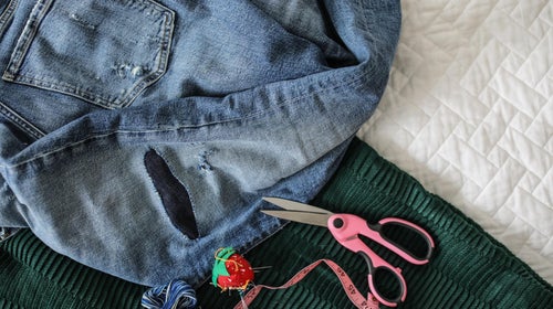 Pair of ripped jeans being repaired