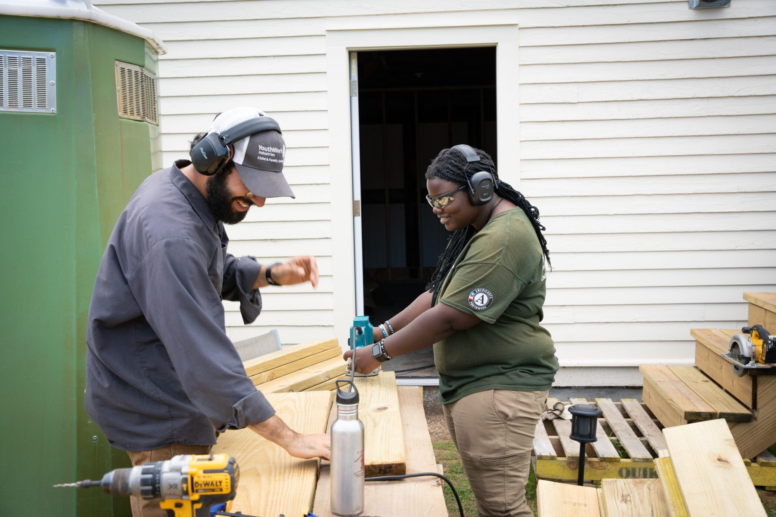 Two teens work on a restoration project